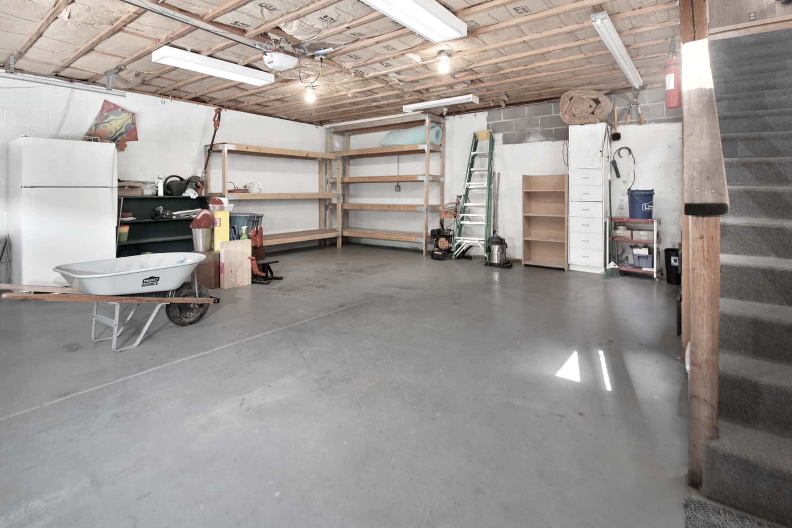A clean, tidy garage workshop interior lit by daylight