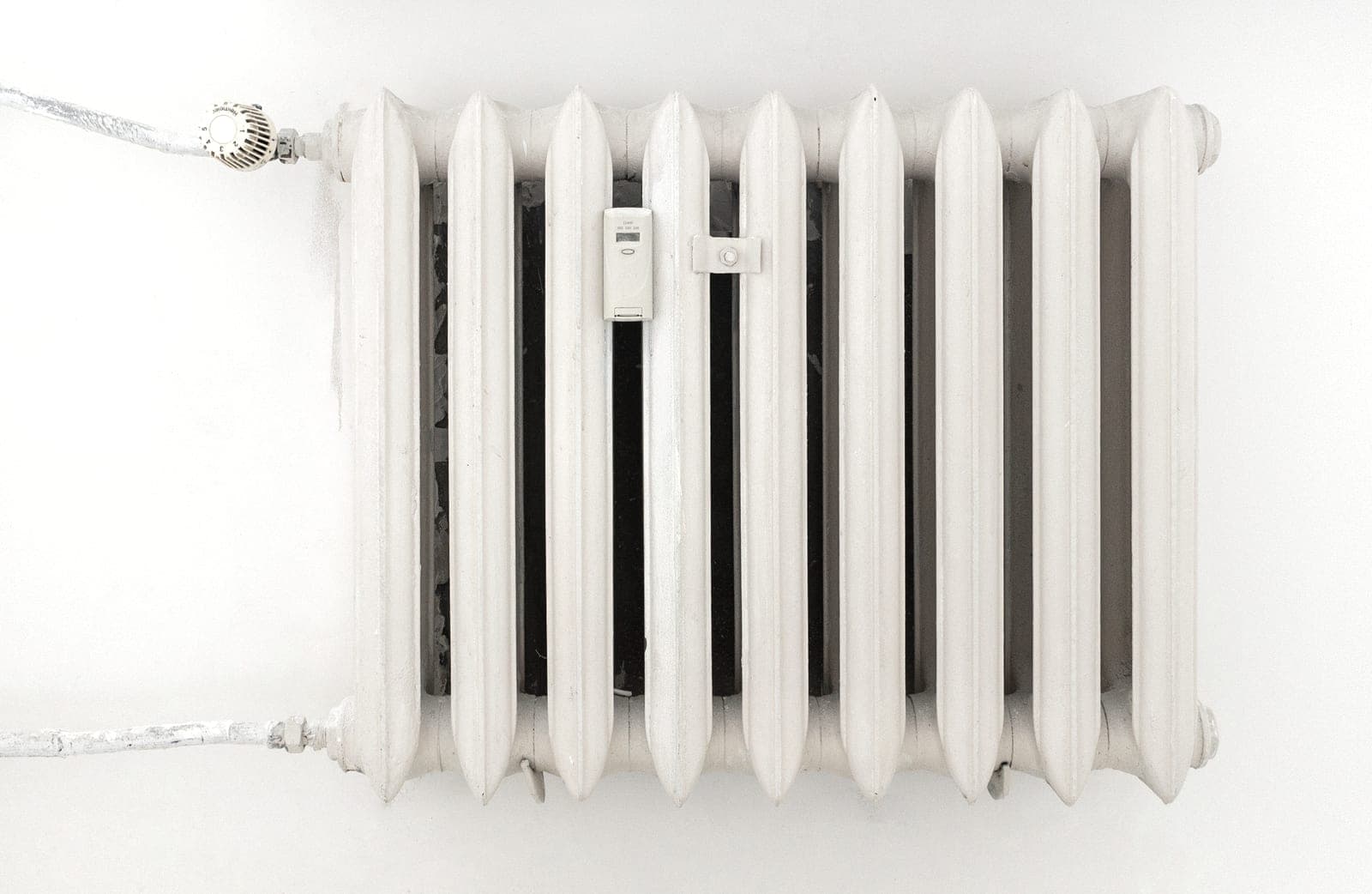 A small portable electric heater standing in a bright, sparsely furnished room